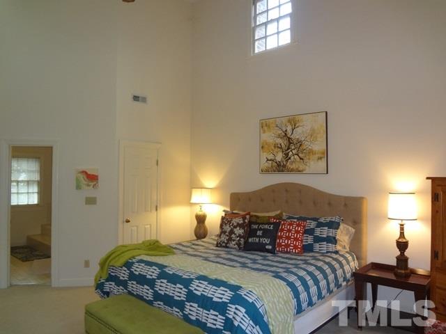 1400 October Road Raleigh, NC 27614 - Photo 11 of 25 a bedroom with a bed and a painting on the wall