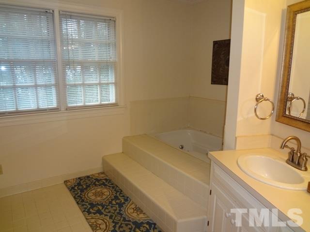 1400 October Road Raleigh, NC 27614 - Photo 12 of 25 a bathroom with a sink and a bathtub