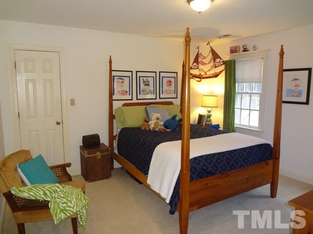 1400 October Road Raleigh, NC 27614 - Photo 14 of 25 a bedroom with a bed chair and window