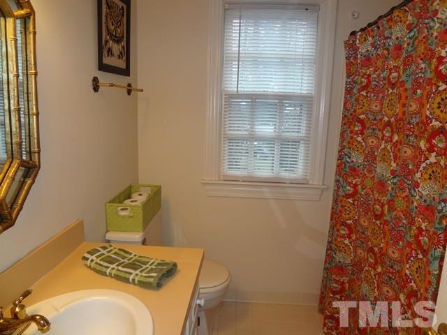 1400 October Road Raleigh, NC 27614 - Photo 15 of 25 a bathroom with a sink and toilet