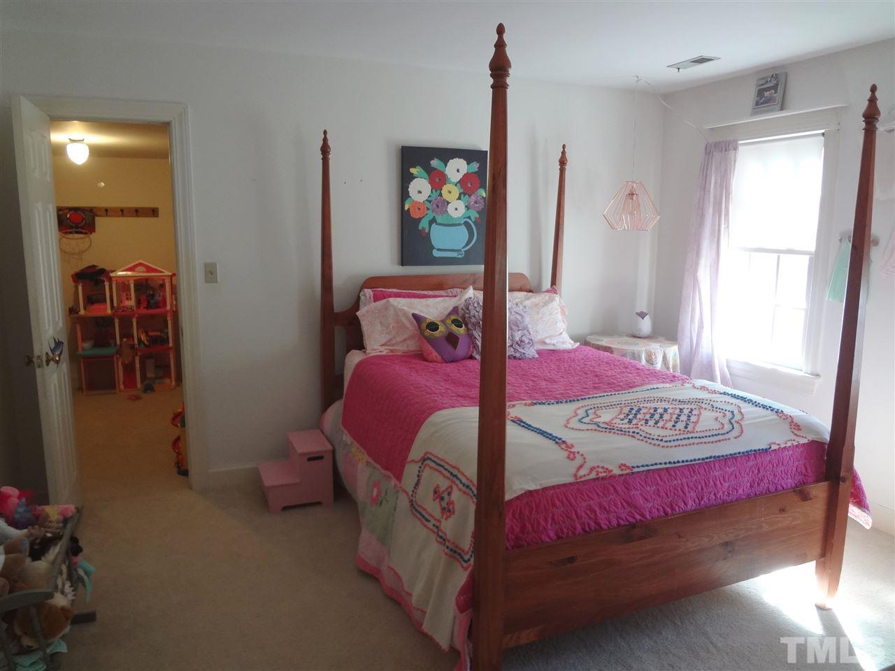 1400 October Road Raleigh, NC 27614 - Photo 16 of 25 a bedroom with a bed and a table in it
