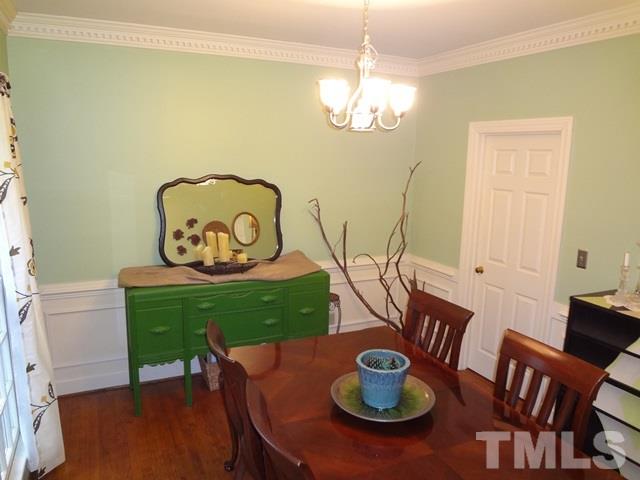 1400 October Road Raleigh, NC 27614 - Photo 3 of 25 a view of a dining room with furniture and wooden floor