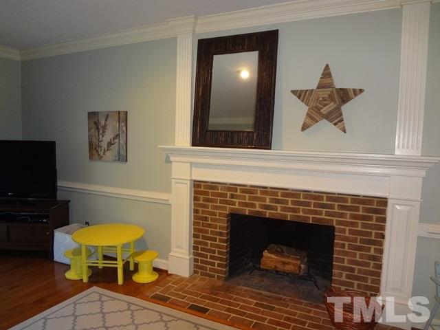 1400 October Road Raleigh, NC 27614 - Photo 5 of 25 a living room with a fireplace and a flat screen tv