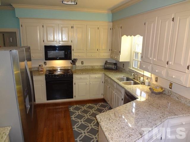 1400 October Road Raleigh, NC 27614 - Photo 6 of 25 a kitchen with a sink appliances and cabinets