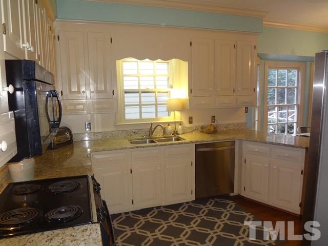 1400 October Road Raleigh, NC 27614 - Photo 9 of 25 a kitchen with a sink stove and refrigerator