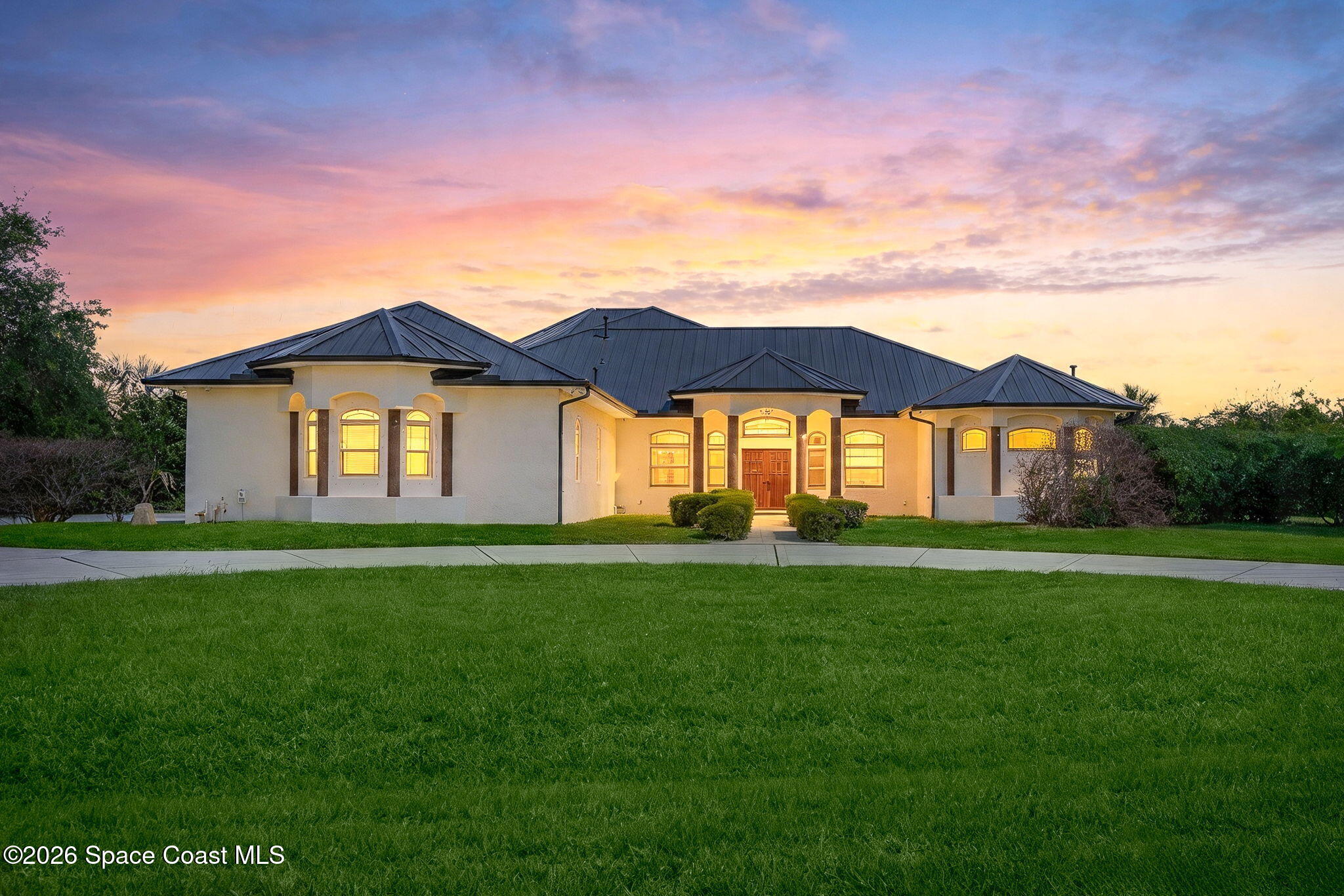 4010 Turkey Point Drive Melbourne, FL 32934 - Photo 1 of 53 a front view of a house with a yard
