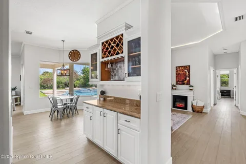 an open kitchen with furniture and wooden floor