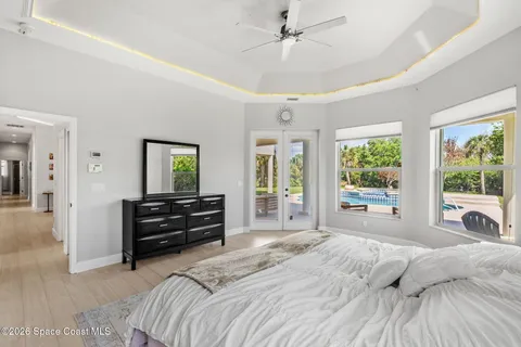 a spacious bedroom with a bed and a large window