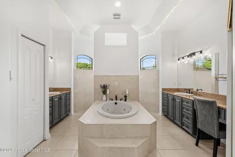 a large bathroom with a tub and a sink