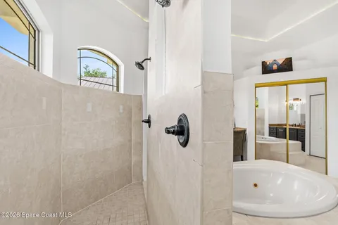 a spacious bedroom with a bed and glass door