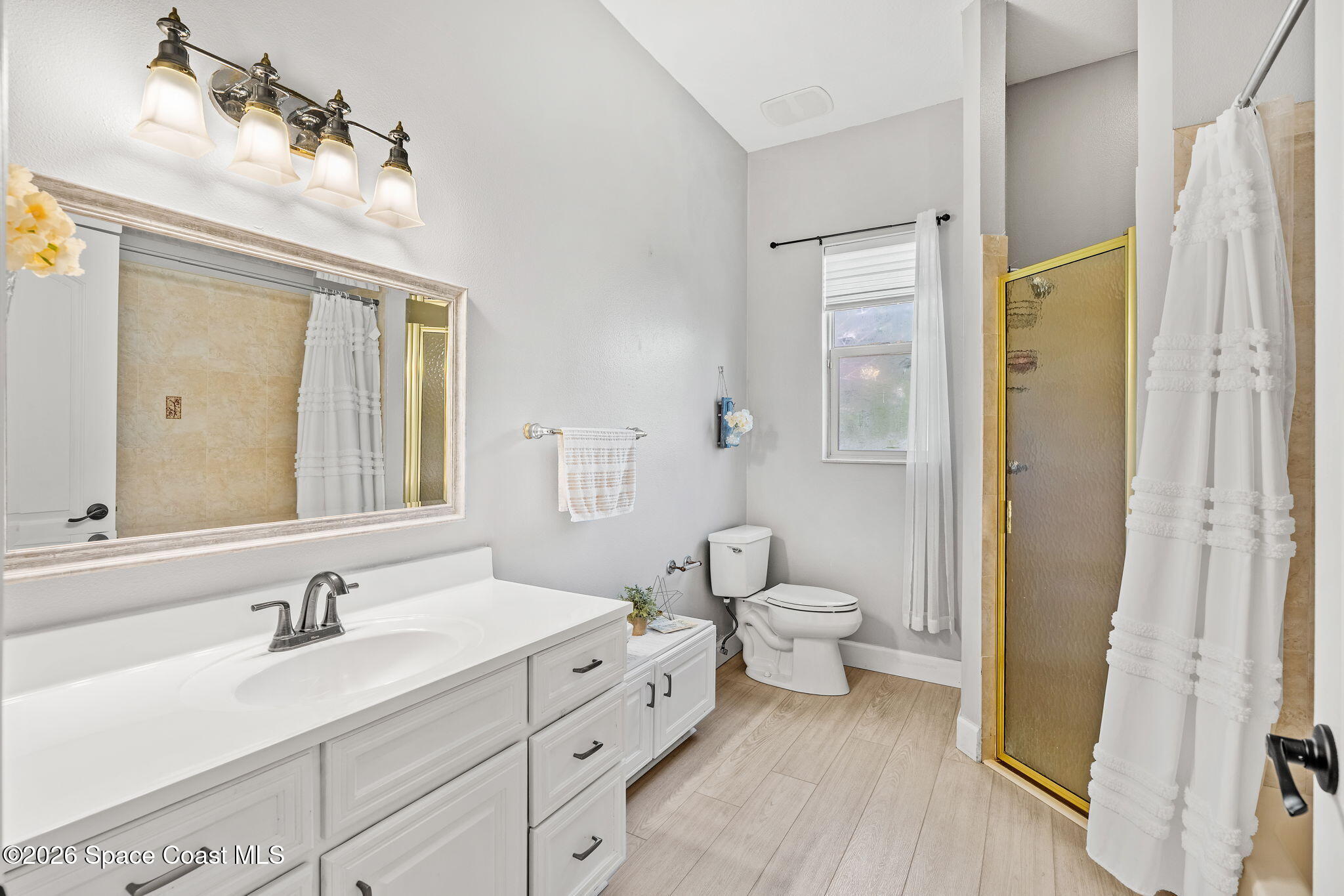 4010 Turkey Point Drive Melbourne, FL 32934 - Photo 23 of 53 a spacious bathroom with a double vanity sink a mirror and a shower