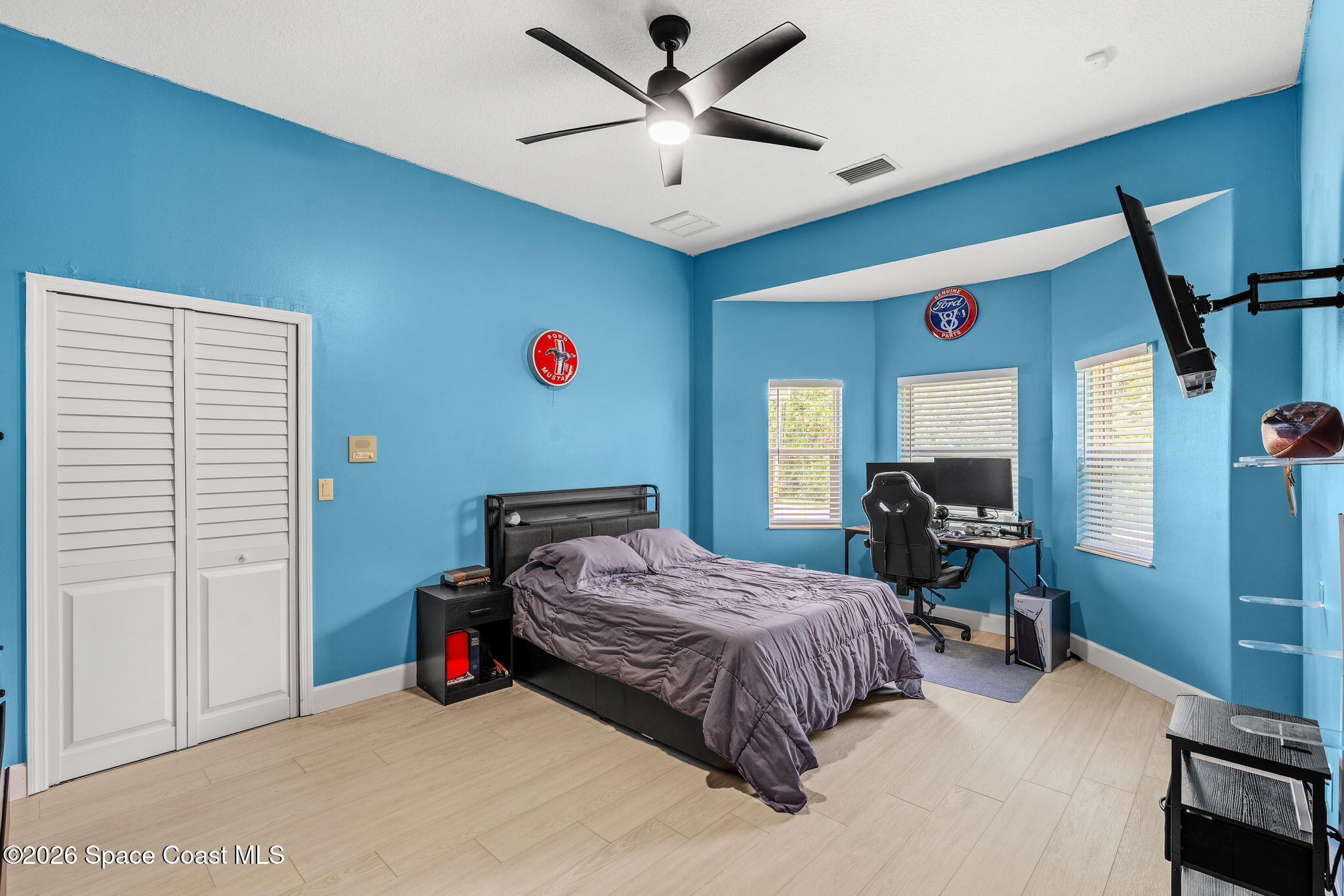 4010 Turkey Point Drive Melbourne, FL 32934 - Photo 24 of 53 a bedroom with a bed a desk and chair