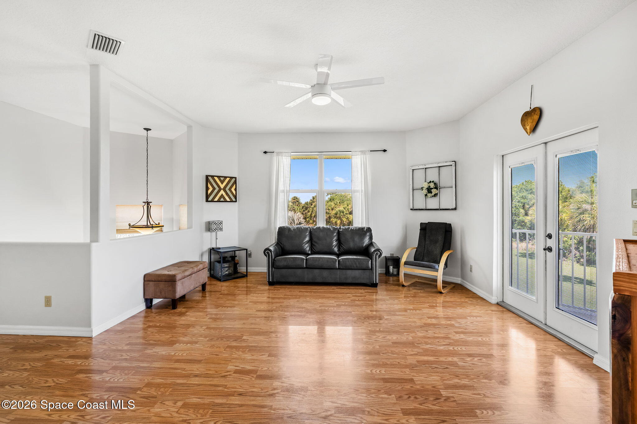 4010 Turkey Point Drive Melbourne, FL 32934 - Photo 25 of 53 a living room with furniture and a wooden floor