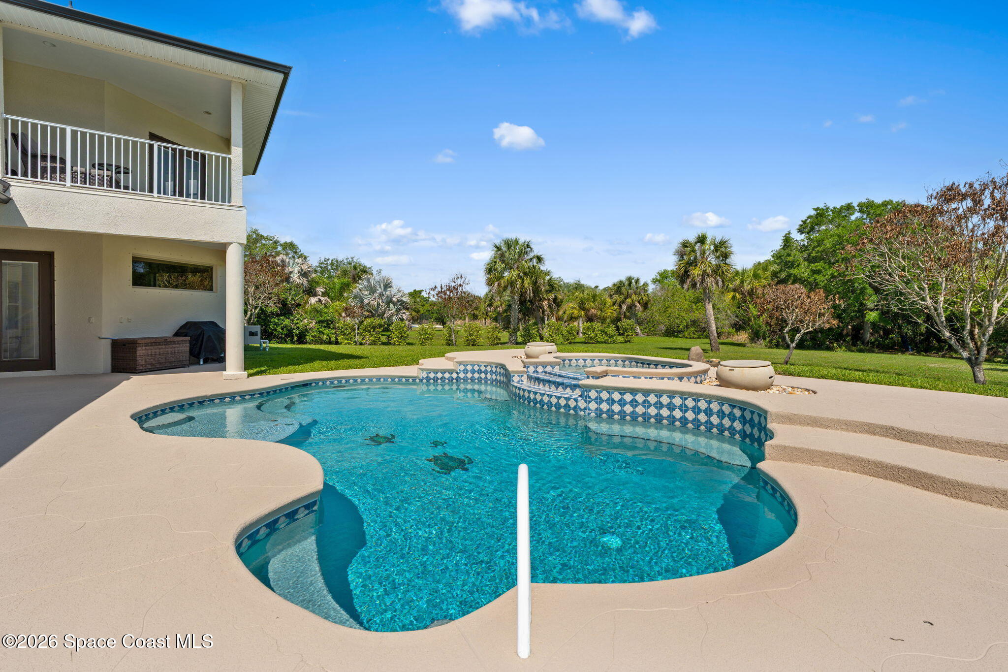 4010 Turkey Point Drive Melbourne, FL 32934 - Photo 38 of 53 a view of a swimming pool with a yard