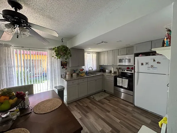 a kitchen with refrigerator and window