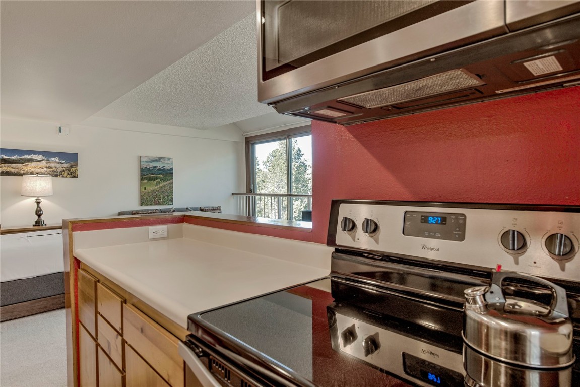22340 Highway 6, Unit 1815 Keystone, CO 80435 - Photo 11 of 19 a kitchen with a stove and a microwave