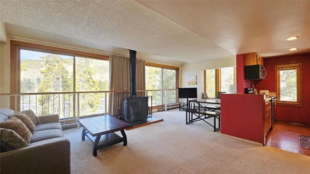 a view of a livingroom with workspace and a window
