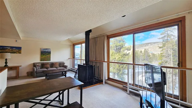 a room with kitchen island granite countertop a sink and a refrigerator