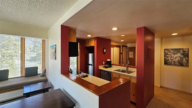 a kitchen with a stove a sink and a refrigerator