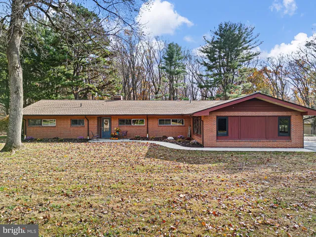 a large house with a big yard and large trees
