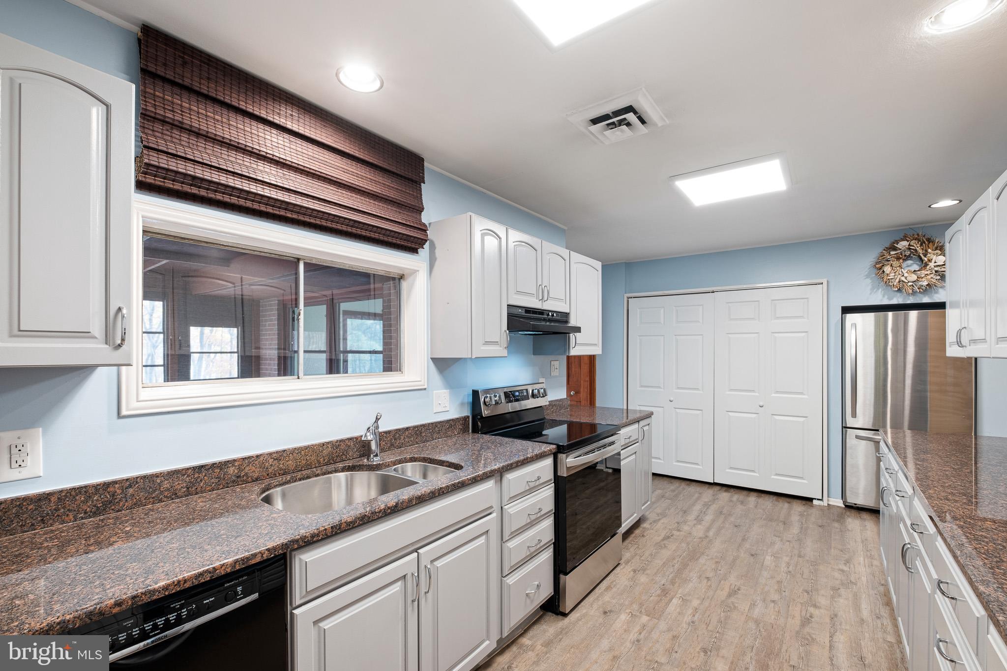 123 Unami Trail Newark, DE 19711 - Photo 13 of 31 a kitchen with stainless steel appliances granite countertop a sink stove and refrigerator