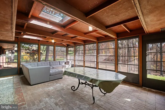 a living room with furniture and a floor to ceiling window