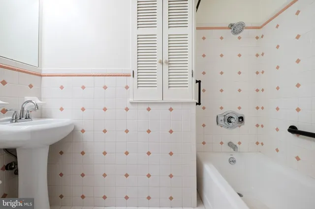 a bathroom with a bathtub and a sink