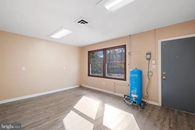 a view of room with window and wooden floor