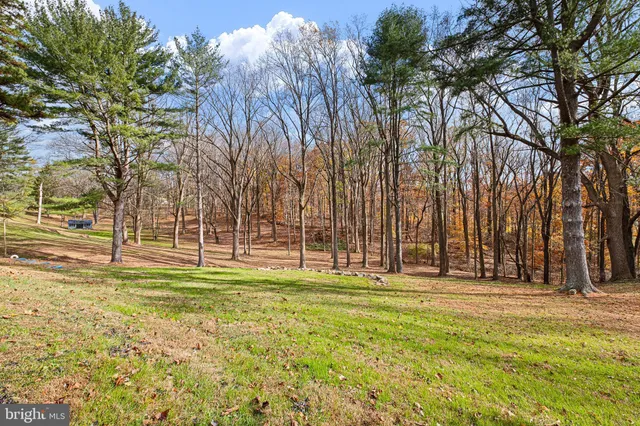 a swimming pool with outdoor seating and yard