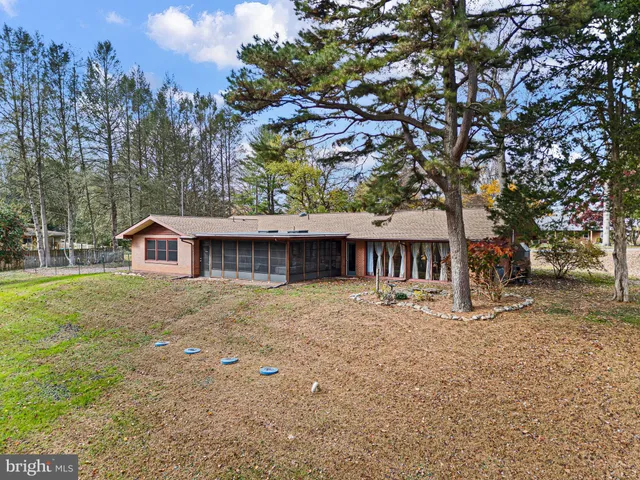 a large house with large trees in front of it
