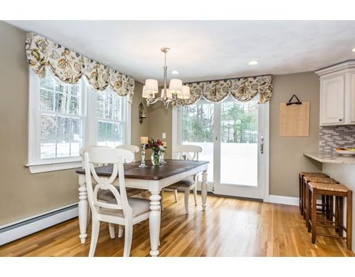 131 Cardigan Road Tewksbury, MA 01876 - Photo 12 of 30 a dining room with wooden floor a chandelier a glass table and chairs