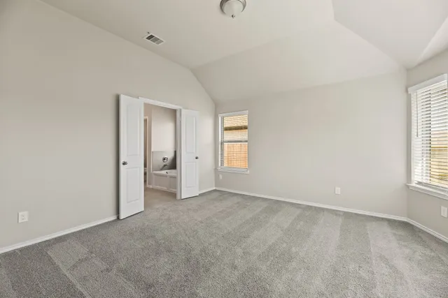 an empty room with windows and closet