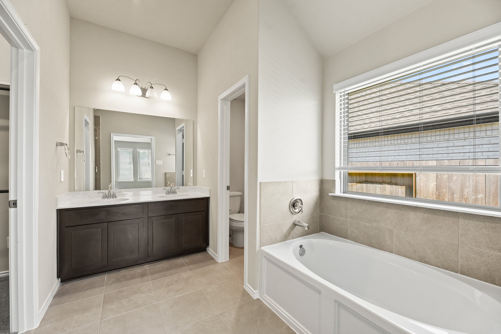 1330 Lakeside Creek Road Magnolia, TX 77354 - Photo 12 of 28 a bathroom with a tub a sink and a mirror