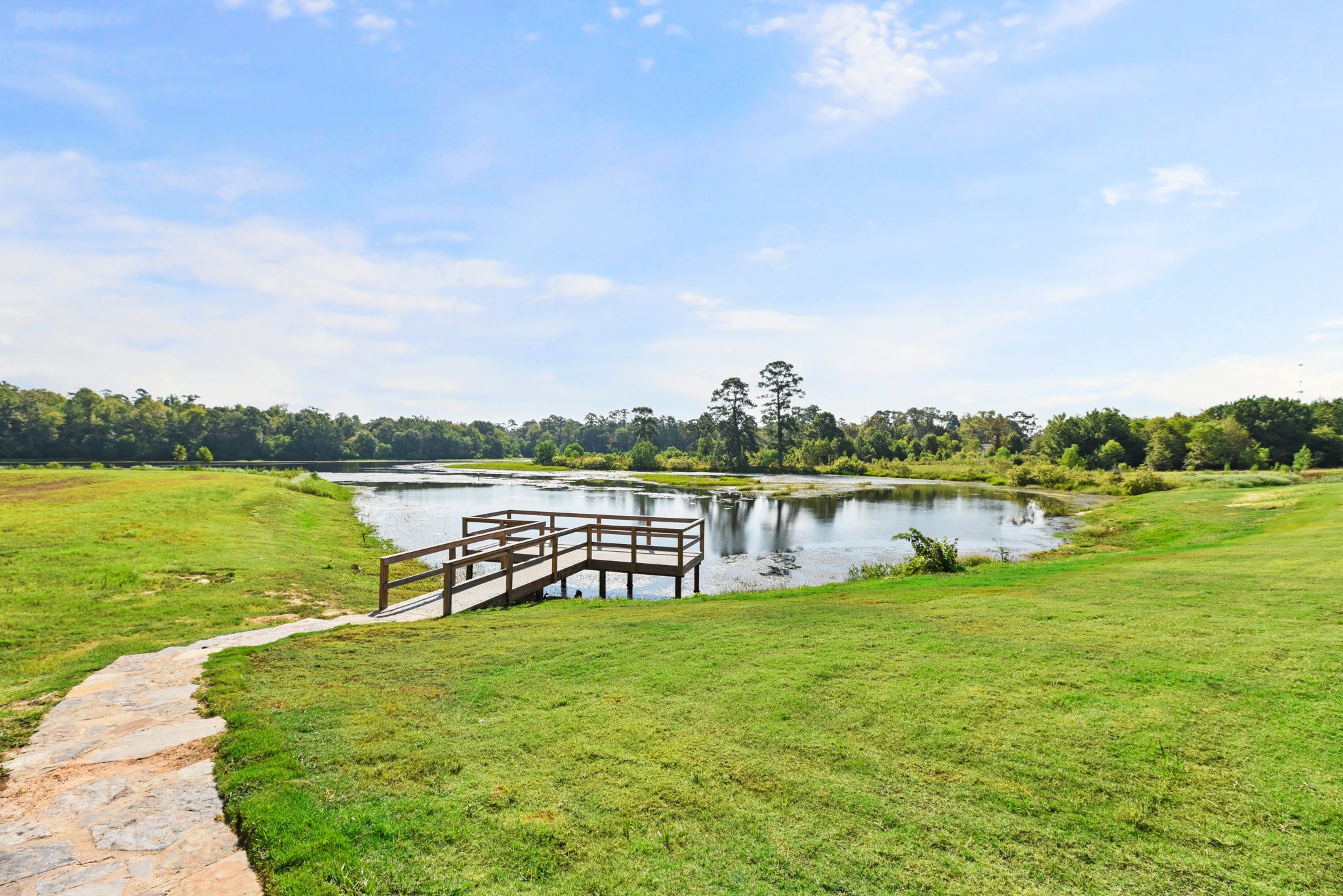 1330 Lakeside Creek Road Magnolia, TX 77354 - Photo 24 of 28 a view of a lake with houses in the back
