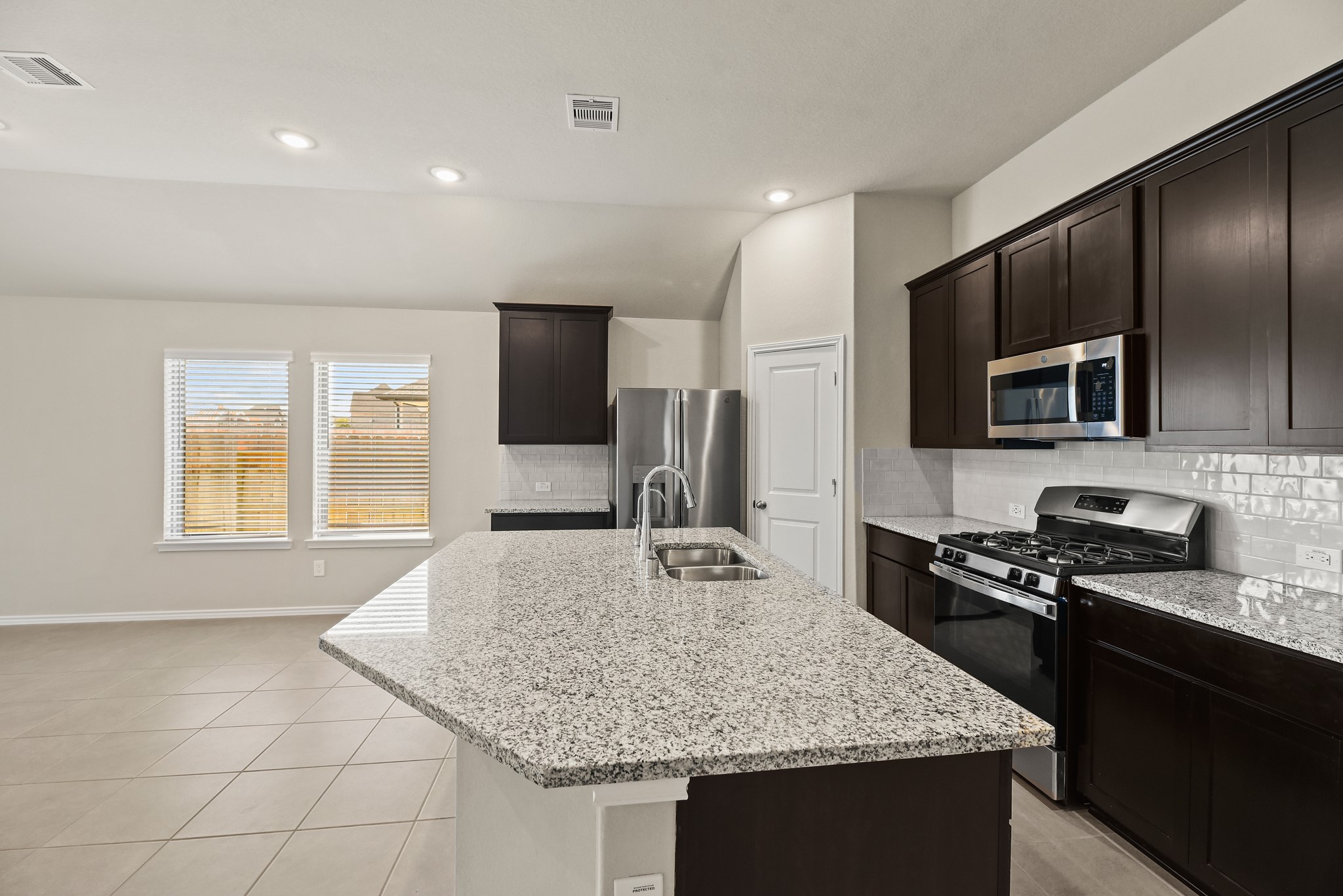1330 Lakeside Creek Road Magnolia, TX 77354 - Photo 7 of 28 a kitchen with kitchen island granite countertop stainless steel appliances a sink stove and refrigerator