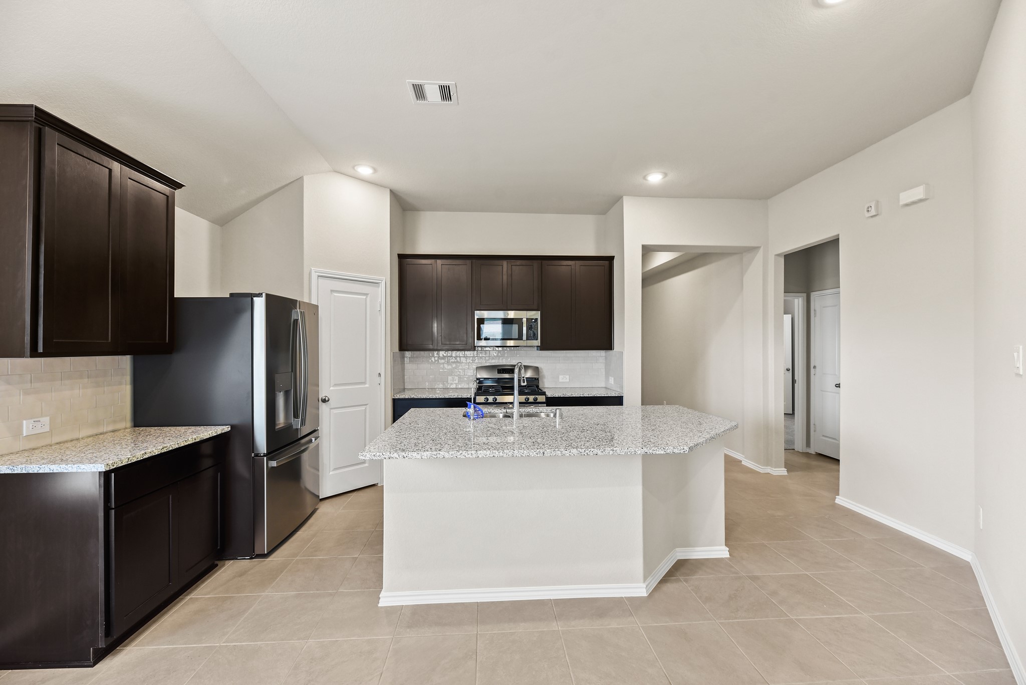 1330 Lakeside Creek Road Magnolia, TX 77354 - Photo 8 of 28 a kitchen with stainless steel appliances a refrigerator and a stove