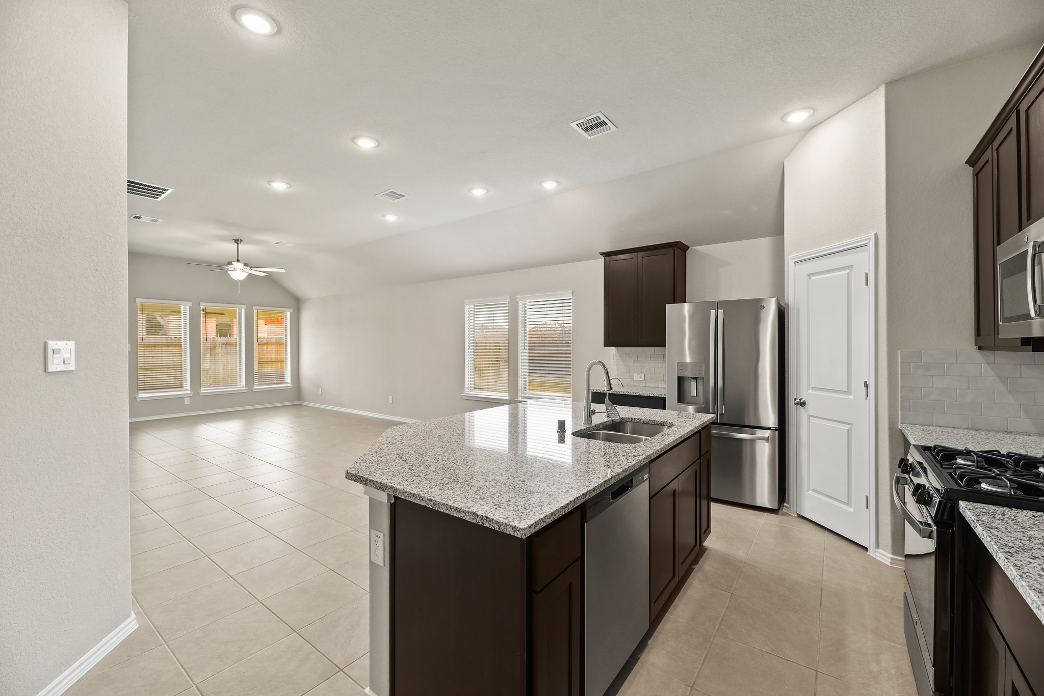 1330 Lakeside Creek Road Magnolia, TX 77354 - Photo 9 of 28 a kitchen with stainless steel appliances granite countertop a sink stove and refrigerator