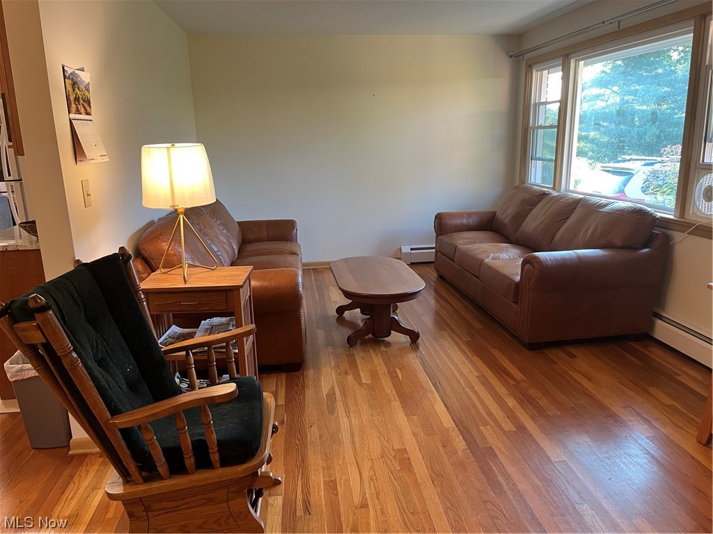 12764 Huntoon Road Painesville, OH 44077 - Photo 17 of 35 Hardwood floored living room featuring new natural gas hot water baseboard heating for maximum comfort.