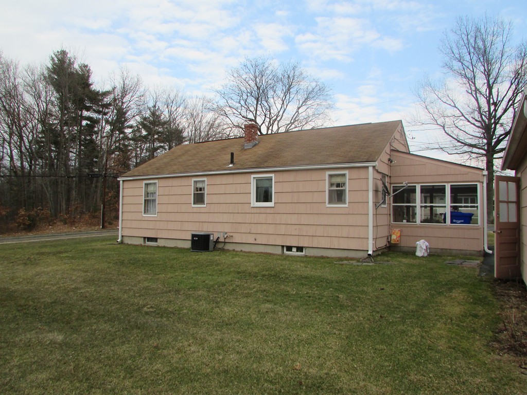 6 Wilshire Road Springfield, MA 01118 - Photo 3 of 10 a front view of a house with a yard
