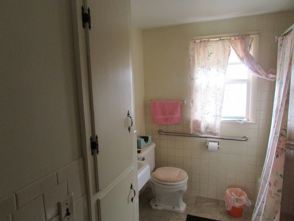 6 Wilshire Road Springfield, MA 01118 - Photo 6 of 10 a bathroom with a toilet a sink and a window