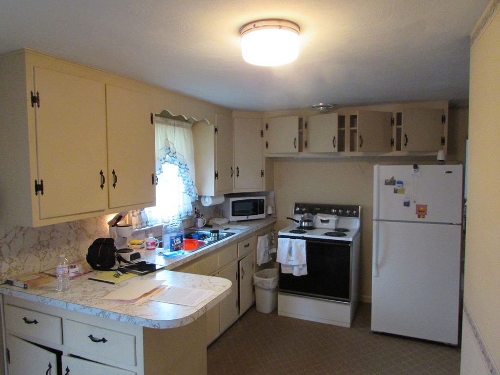 6 Wilshire Road Springfield, MA 01118 - Photo 7 of 10 a kitchen with kitchen island a sink stove and refrigerator