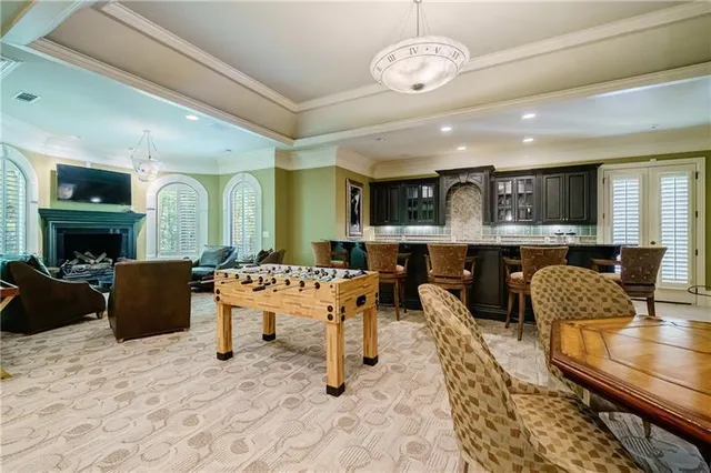 a living room with furniture a fireplace and a chandelier