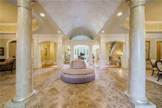 a living room with furniture and a large mirror