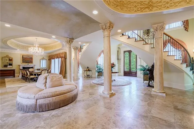 a living room with furniture and a chandelier
