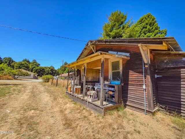 a front view of house with a garden
