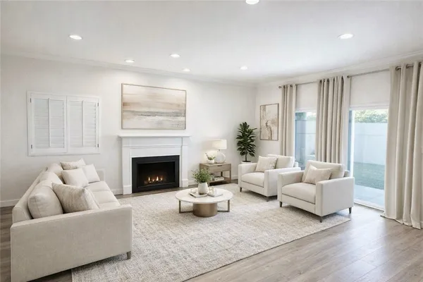an empty room with wooden floor and fireplace