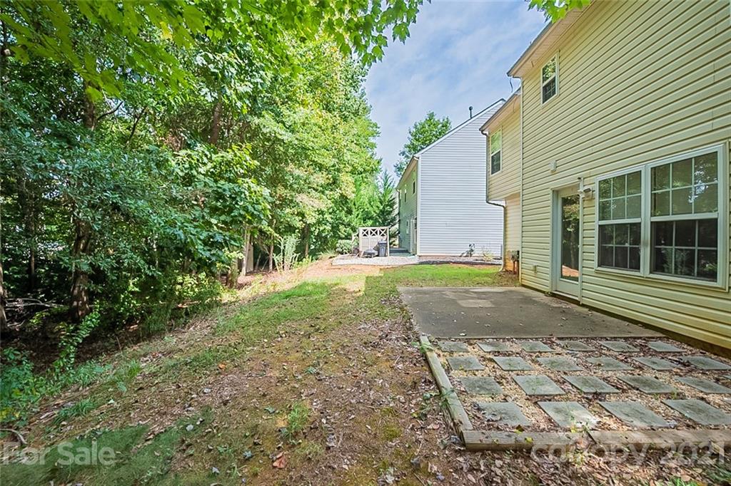 1827 Endeavor Lane Clover, SC 29710 - Photo 17 of 18 a view of a yard with plants and wooden fence