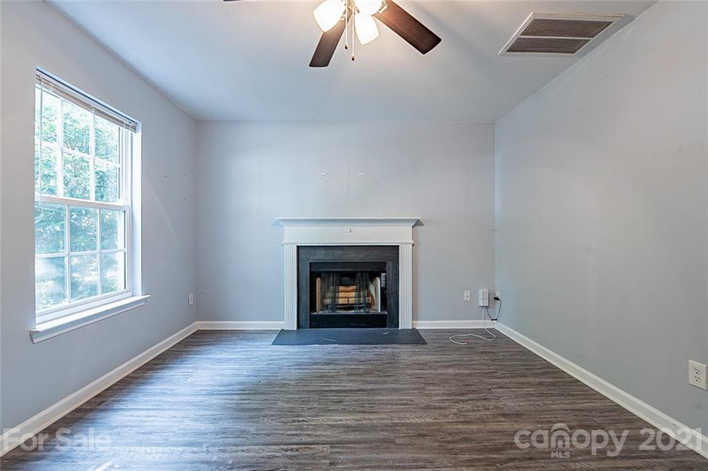 1827 Endeavor Lane Clover, SC 29710 - Photo 4 of 18 a view of an empty room with wooden floor fireplace and window
