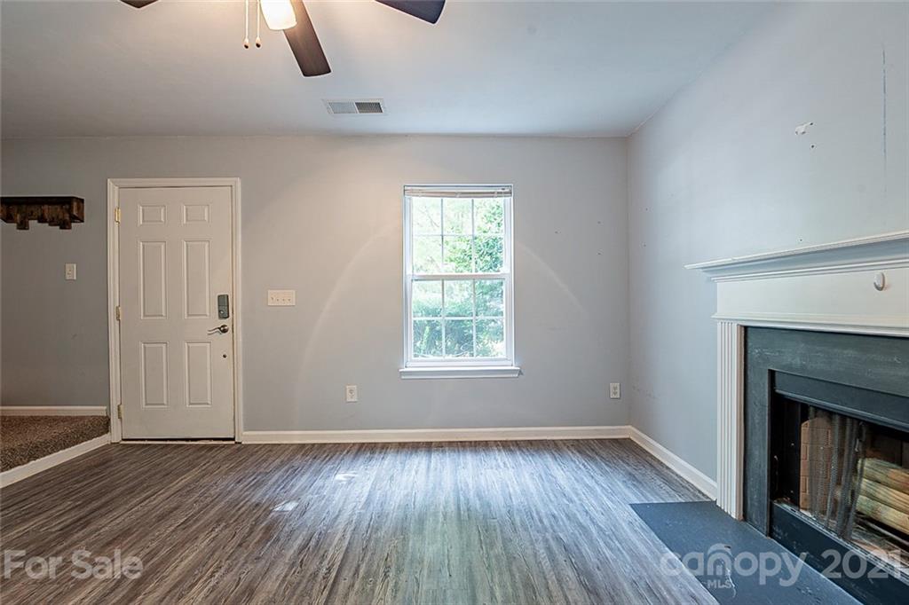1827 Endeavor Lane Clover, SC 29710 - Photo 5 of 18 an empty room with ceiling fan fireplace and window
