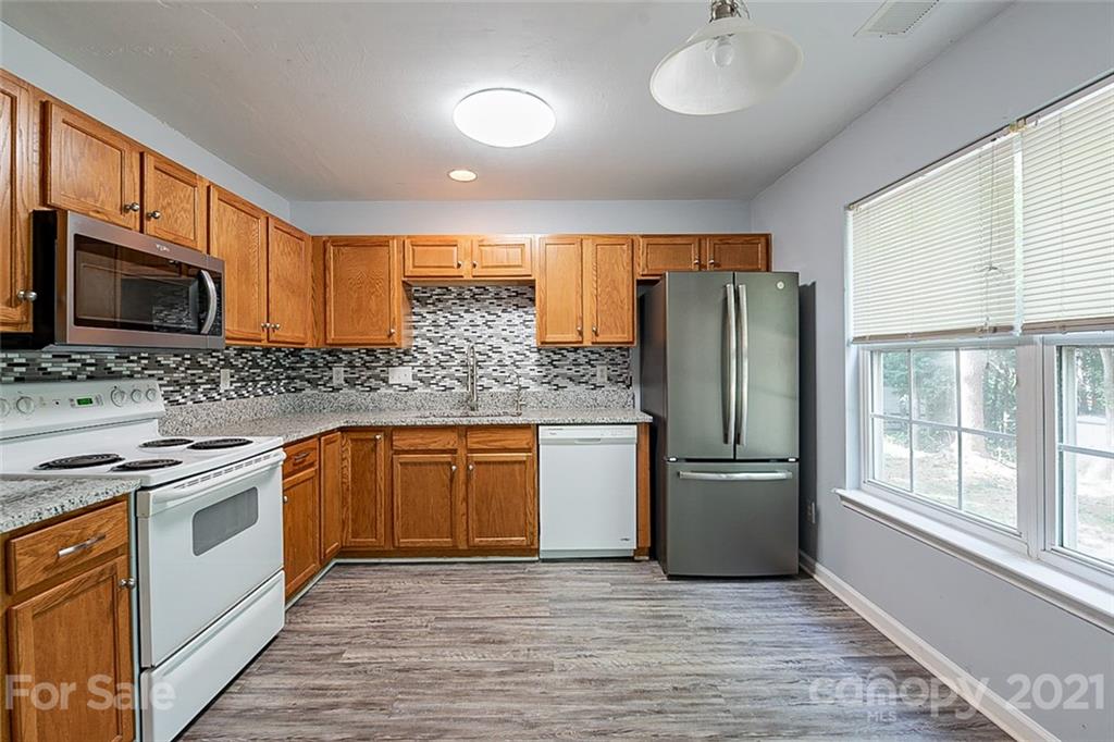 1827 Endeavor Lane Clover, SC 29710 - Photo 7 of 18 a kitchen with stainless steel appliances granite countertop a refrigerator stove and sink